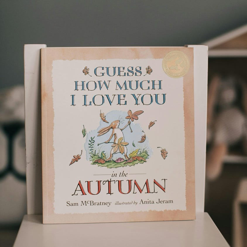 Cover of a children's book 'Guess How Much I Love You' with autumn illustrations.